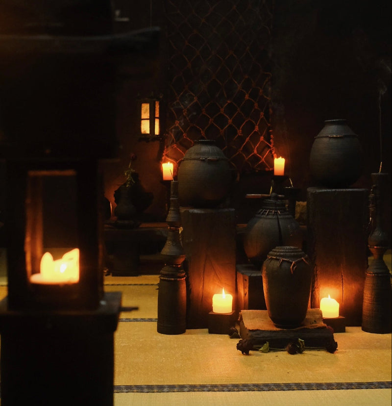 Traditional Japanese interior with lanterns and candles creating a warm atmosphere.